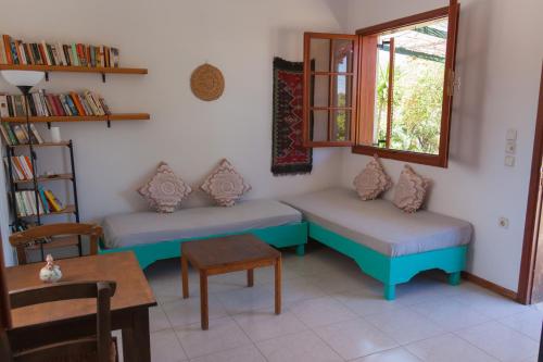 a room with two benches and a table and a window at Atheneon Rhodes in Theologos