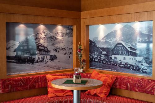 a room with two pictures on the wall and a table at Hotel Wagner in Obertauern