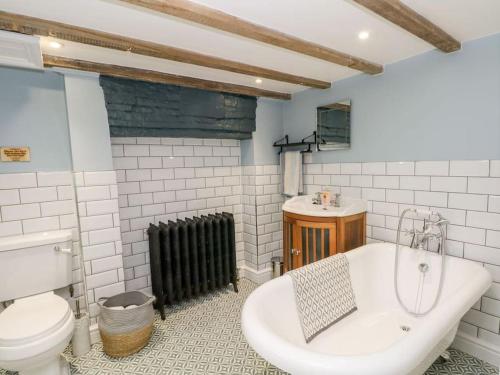 a bathroom with a tub and a toilet and a sink at North View Cottage - Log burner,Views,Parking,walks,Peak District,Dogs in Rainow