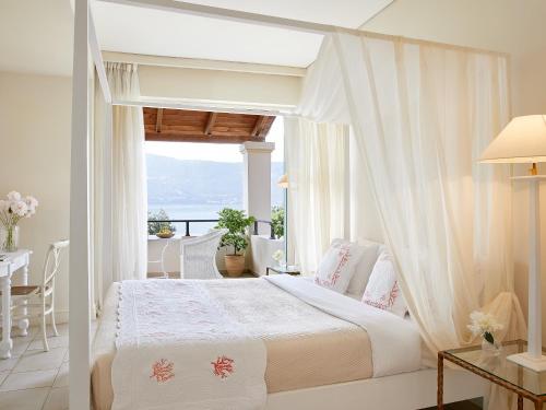 A bed or beds in a room at Grecotel Eva Palace