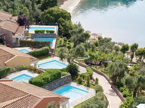 an aerial view of a villa with two swimming pools at Grecotel Eva Palace in Kommeno