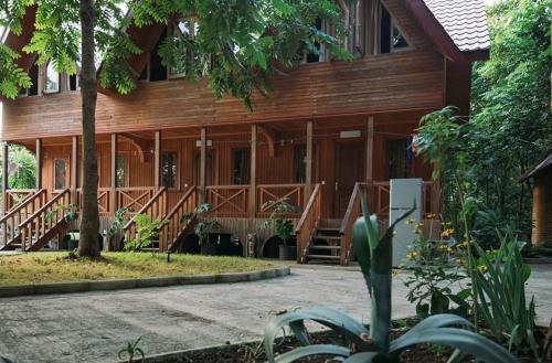 a wooden building with a staircase in front of it at Shekhvetili Cottages 2N in Shekvetili