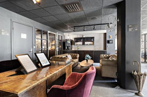 a living room with a wooden table and chairs at Forenom Aparthotel Stockholm Bromma in Stockholm