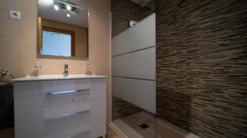 a bathroom with a sink and a stone wall at Lovely Groundfloor Apartment - AA3302LT in Torre-Pacheco