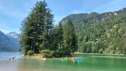 a group of people swimming in a lake at Appartamento incantevole con ampio balcone in Sella Nevea