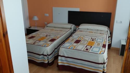 Postel nebo postele na pokoji v ubytování Hotel Mesón El Número Uno