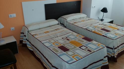 Postel nebo postele na pokoji v ubytování Hotel Mesón El Número Uno
