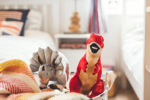 two stuffed animals are sitting in a basket at Waves - Sea View Duplex Apartment, Stoke Fleming in Stoke Fleming