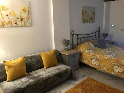 a living room with a couch and a bed at Daffodil House Annex, Cynghordy, West Wales in Llandovery