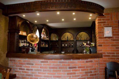 a bar in a restaurant with a brick wall at Noclegi U Kawalca in Szczecinek