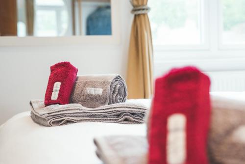 a newspaper and a pair of red shoes on a table at Waves - Sea View Duplex Apartment, Stoke Fleming in Stoke Fleming