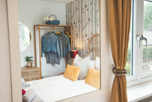 a bedroom with a bed and a mirror at Waves - Sea View Duplex Apartment, Stoke Fleming in Stoke Fleming