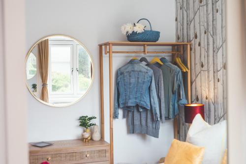 a mirror hanging on a wall next to a bedroom at Waves - Sea View Duplex Apartment, Stoke Fleming in Stoke Fleming