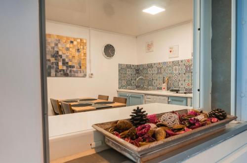 a kitchen with a table with a tray of food at sur la route du voile meublé hibiscus in Salazie