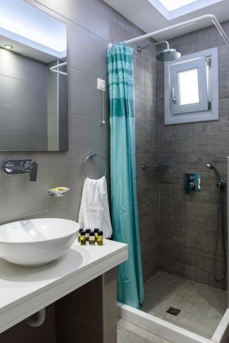 a bathroom with a sink and a shower at Glaros Hotel in Kamari