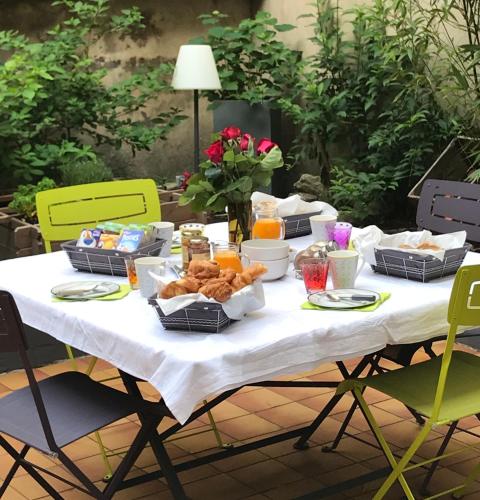 a table with food on it with green chairs at -- La main à la pâte -- in Boulogne-sur-Mer