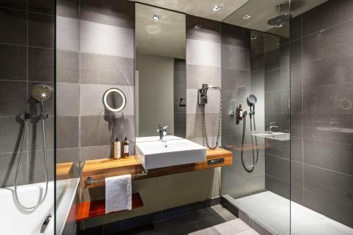 a bathroom with a sink, toilet and bathtub at Clarion Congress Hotel Bratislava in Bratislava