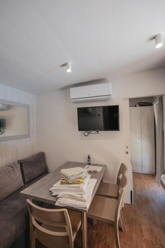 a small living room with a table and a couch at River huts Zrmanja in Obrovac