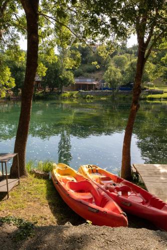 three kayaks sitting on the shore of a lake at River huts Zrmanja in Obrovac