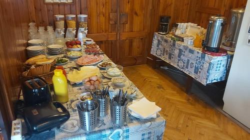 a table with many different types of food on it at Penzion Diana in Železná Ruda
