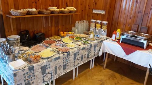 a table with plates of food on it at Penzion Diana in Železná Ruda