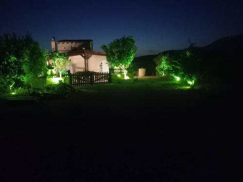 a house with lights in the yard at night at Chrisi`s house with jacuzzi in Moírai