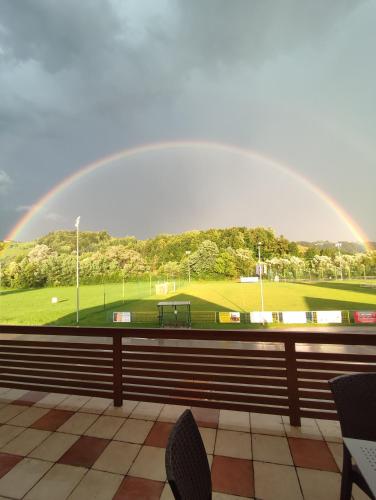 a rainbow over a golf course with a green at Apartments Vila Leska in Zgornji Leskovec