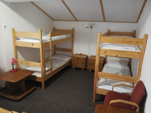 a room with three bunk beds in a room at Penzion Diana in Železná Ruda