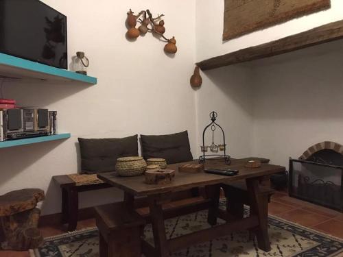 a living room with a wooden table and a couch at Casa da Ti Gorda Alojamento Local Monsaraz - Alentejo - Portugal in Reguengos de Monsaraz