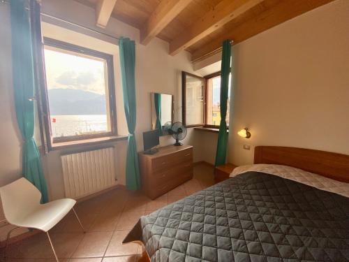 a bedroom with a bed and a large window at Da Mario Apartments in Malcesine