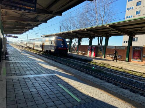 a train on the tracks at a train station at AGM Suite Rome Airport FCO - Attico Parco Leonardo in Fiumicino