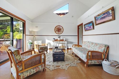 a living room with a couch and chairs and a table at Chalet on Percheron in Margaret River Town