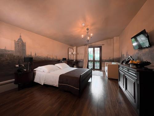 a bedroom with a bed and a television in it at Hotel Boutique Vila 8 in Durrës