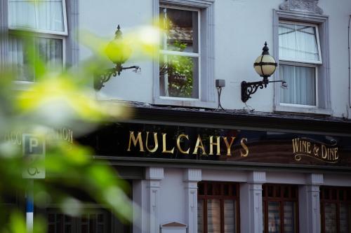 a building with a sign that reads mulberrys at Mulcahys in Clonmel