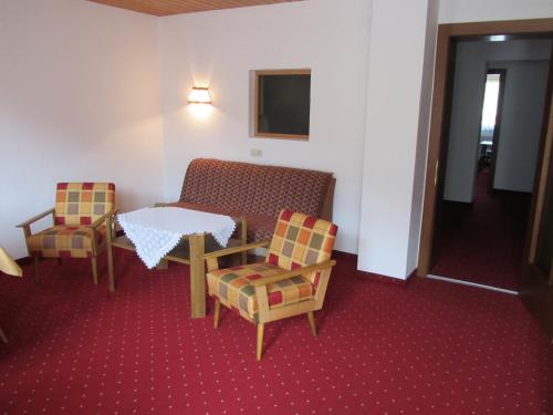 a room with a table and two chairs and a table and a table at Appartements Kroner in Nauders