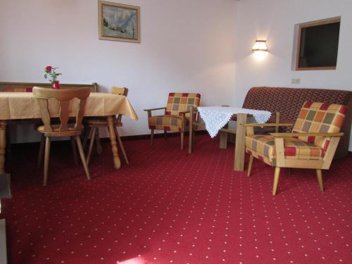 a living room with chairs and a table and a table and a tableablish at Appartements Kroner in Nauders