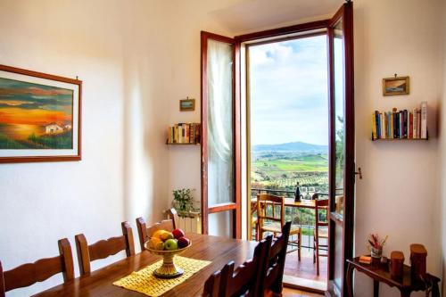 a dining room with a table and a large window at Amazing Tuscany Window in Montemassi