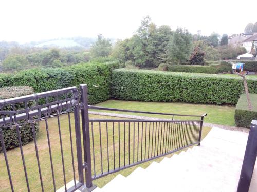 a black gate on a balcony with a garden at The Meadows Bed and Breakfast in Monaghan