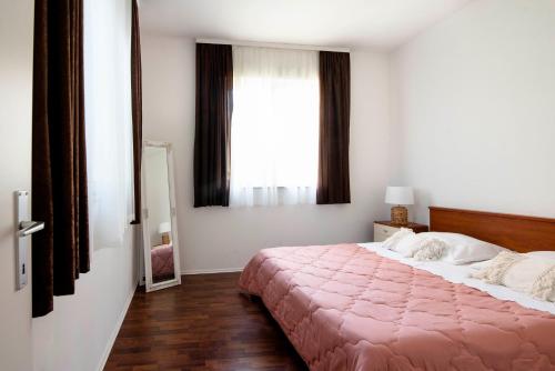 a bedroom with a large bed and a window at Apartment Alkar in Sinj