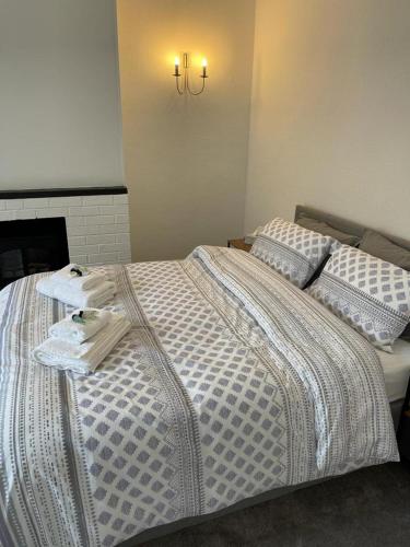 a bedroom with a bed with towels on it at 2-Bed Sleeps 4 Free Parking Pets Allowed in Eastbourne
