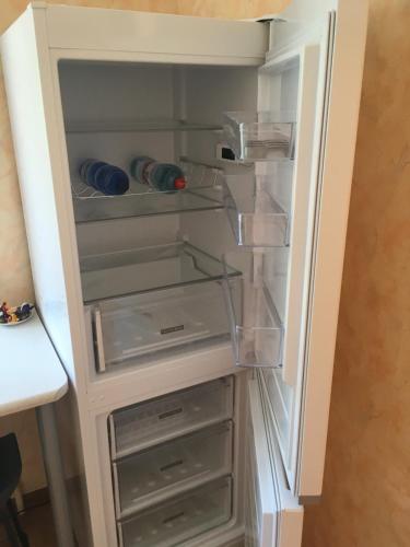 an empty refrigerator with its door open at Apartment near the seaside in Jūrmala