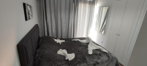 a bedroom with a bed with white bones on it at Ixian House Apartment in Ixia