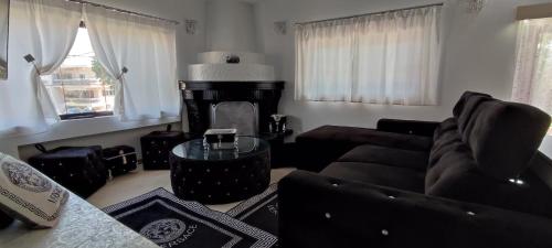 a living room with a couch and a table at Ixian House Apartment in Ixia