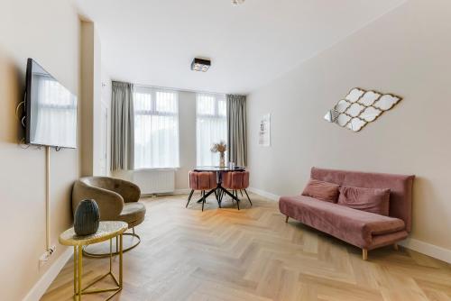 a living room with a couch and a table at Novallure Short Stay Apartments in Leidschendam