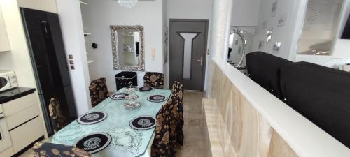 a dining room with a blue table and chairs at Ixian House Apartment in Ixia