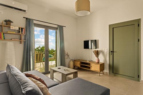 a living room with a couch and a table at Casa Mainotti - Villa in Mani in Nomitsís