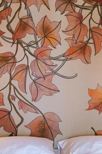 a wall with a mural of leaves on it at Conca Bella Boutique Hotel & Wine Experience in Vacallo
