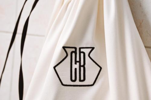 a white jersey with a black logo on it at Conca Bella Boutique Hotel & Wine Experience in Vacallo