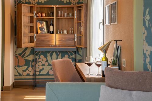 a room with a table with two glasses of wine at Conca Bella Boutique Hotel & Wine Experience in Vacallo