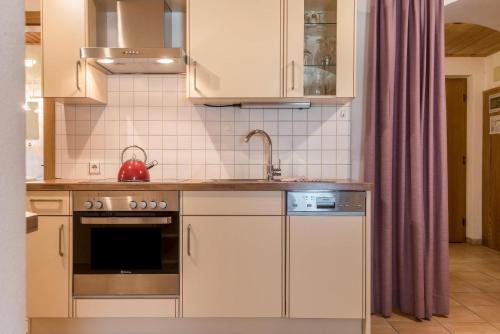 a kitchen with a sink and a stove top oven at Ferienparadies Sabina Santner in Alpe di Siusi